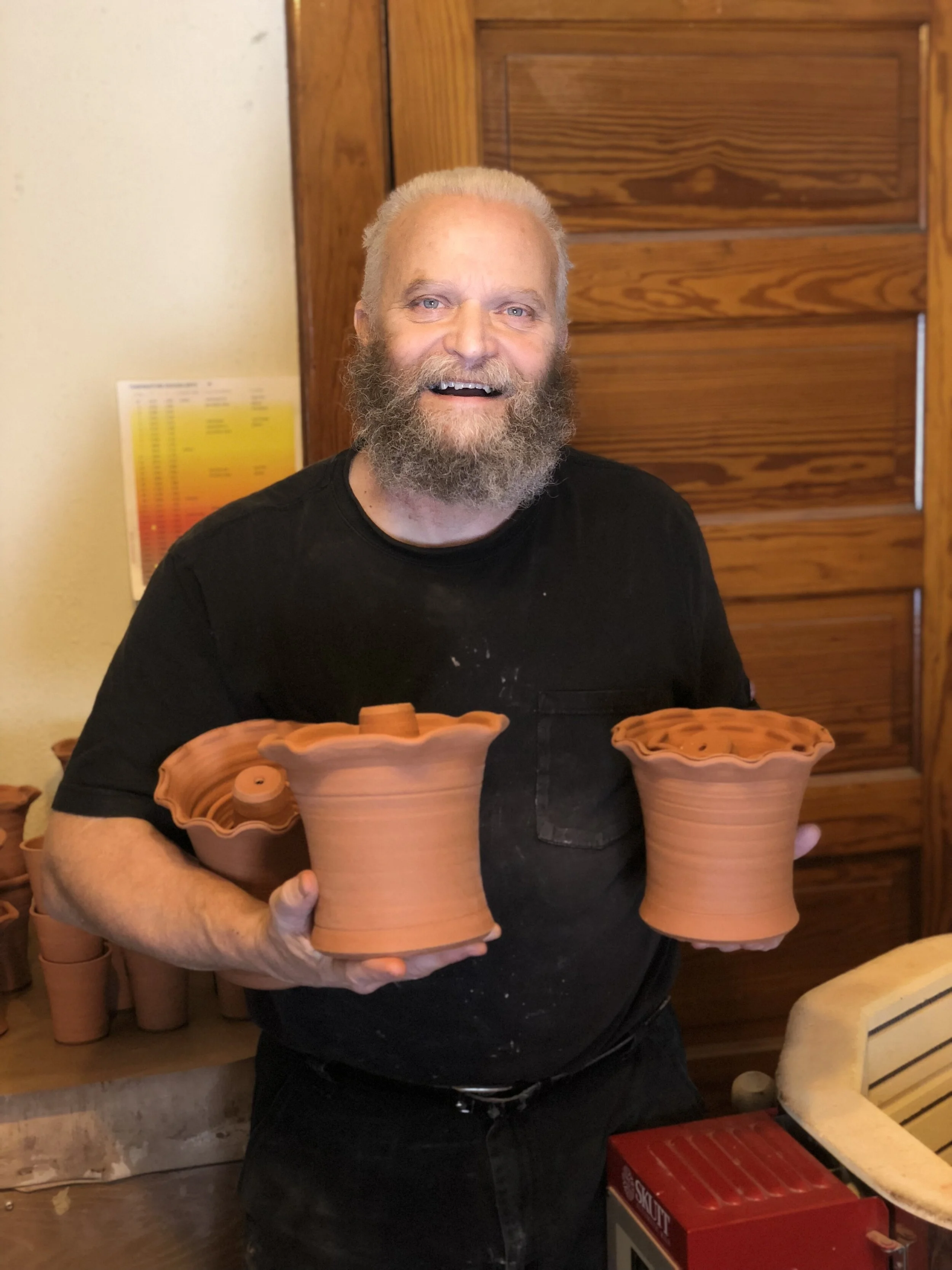Cleve with a handful of frilled edge terra-cotta pots.