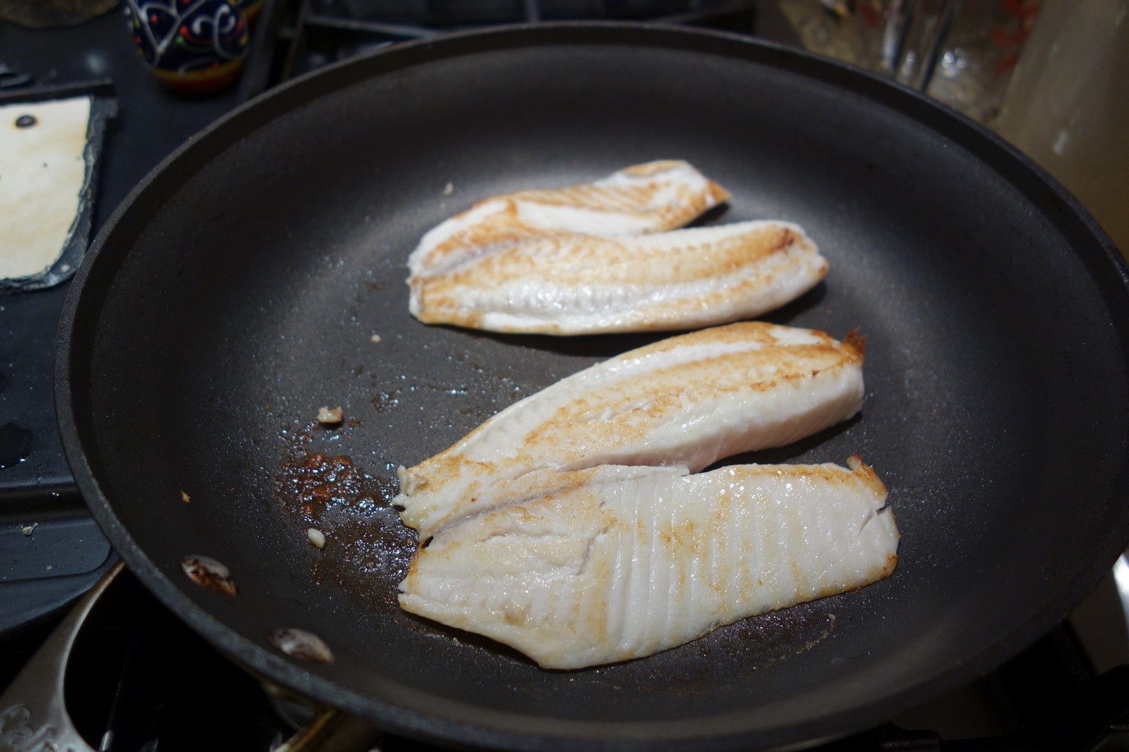 2 Tilapia filets in a large skillet with only a coating of butter. They brown well on medium-high heat, even in a non-stick skillet.