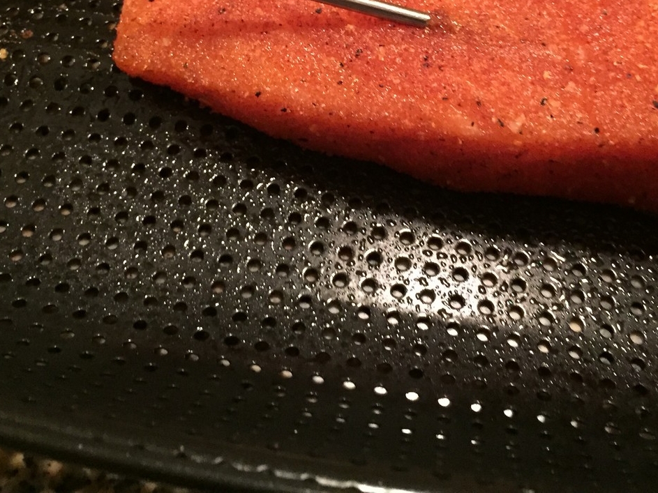 See how it's a flat surface with holes in it, as opposed to a wire mesh grate? This makes a world of difference when trying to clean it.