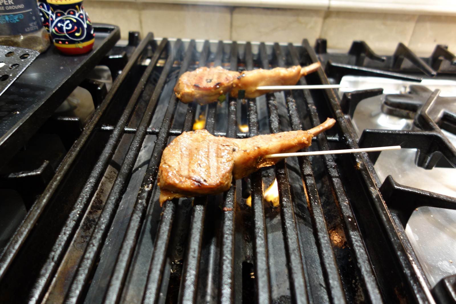After marinating, skewer and place on the grill with the end of the skewers off the grill . . . so you can safely use them to flip the chops.