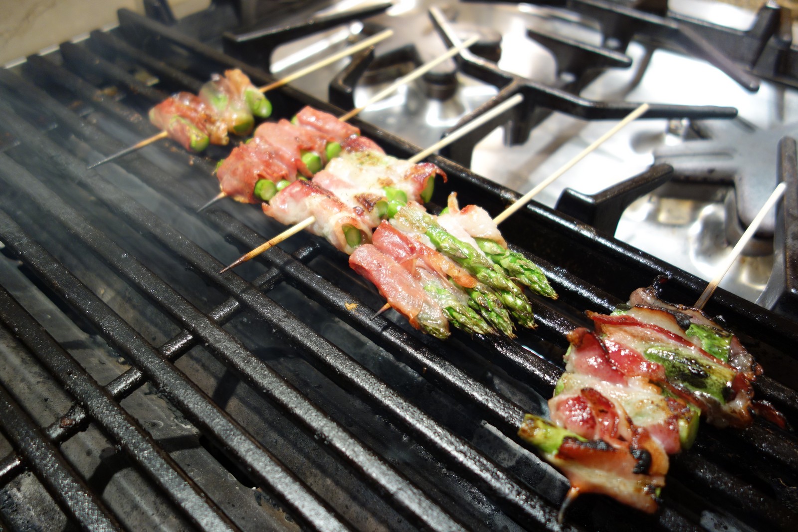 Grill over medium-high or high heat. Leave the ends of the skewers hanging off the grill so you can use them to flip the asparagus.