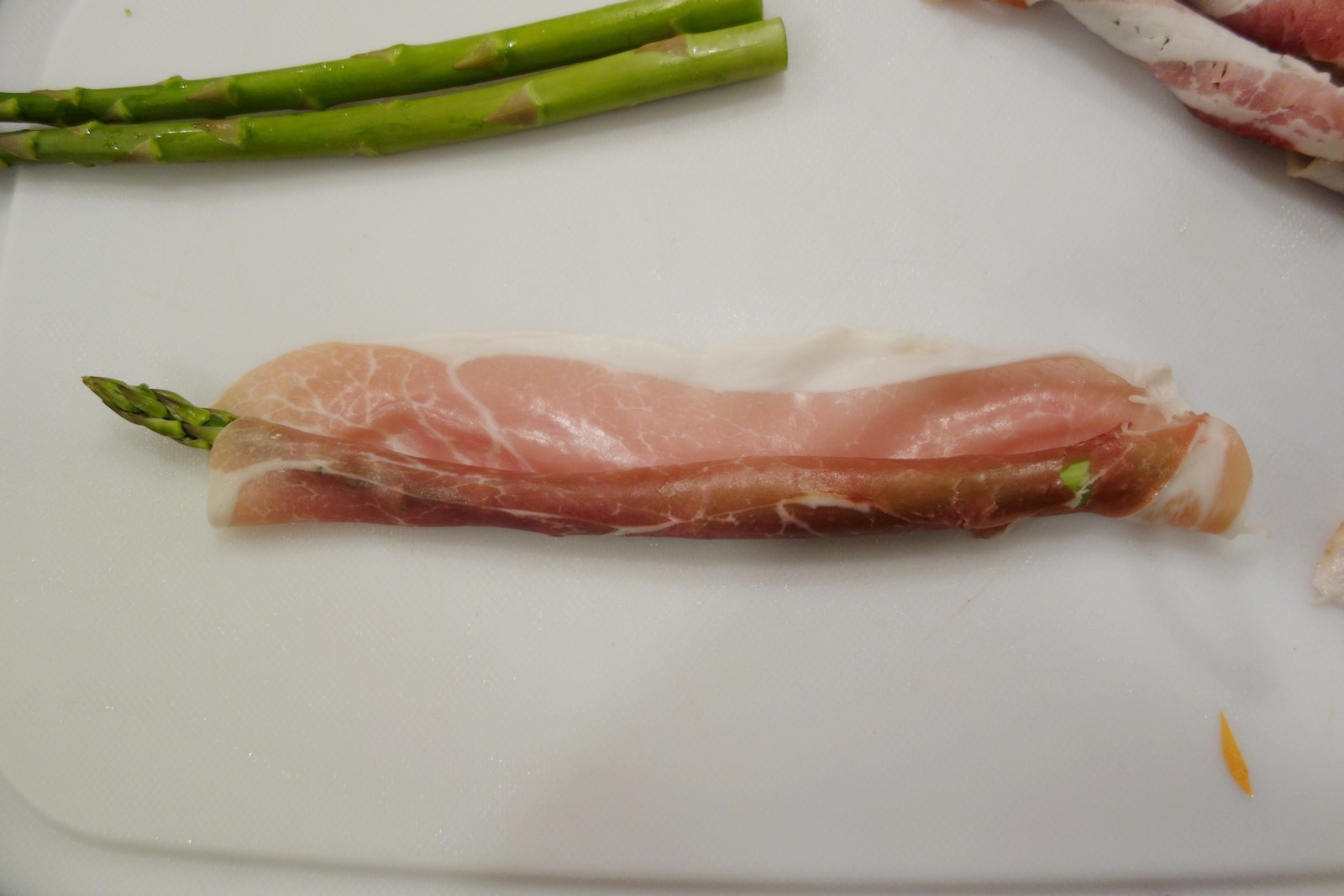 If you use prosciutto, a single slice is thin enough and wide enough to wrap around the asparagus. 
