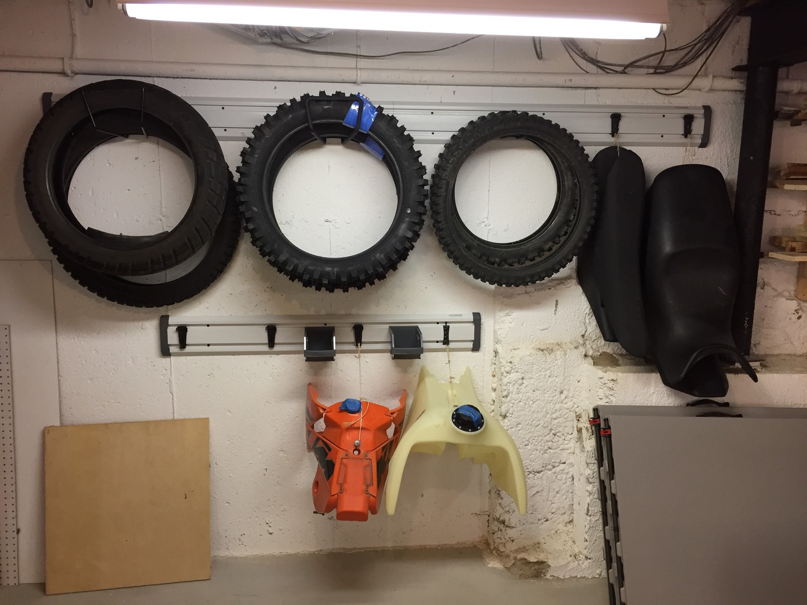 My "Wall of Motorcycles". Deep Hooks can hold tires, hoses, or extension cords. Unusually shaped items, like my gas tanks and motorcycle seats, can be attached to inexpensive "J" or "L" hooks using twine.