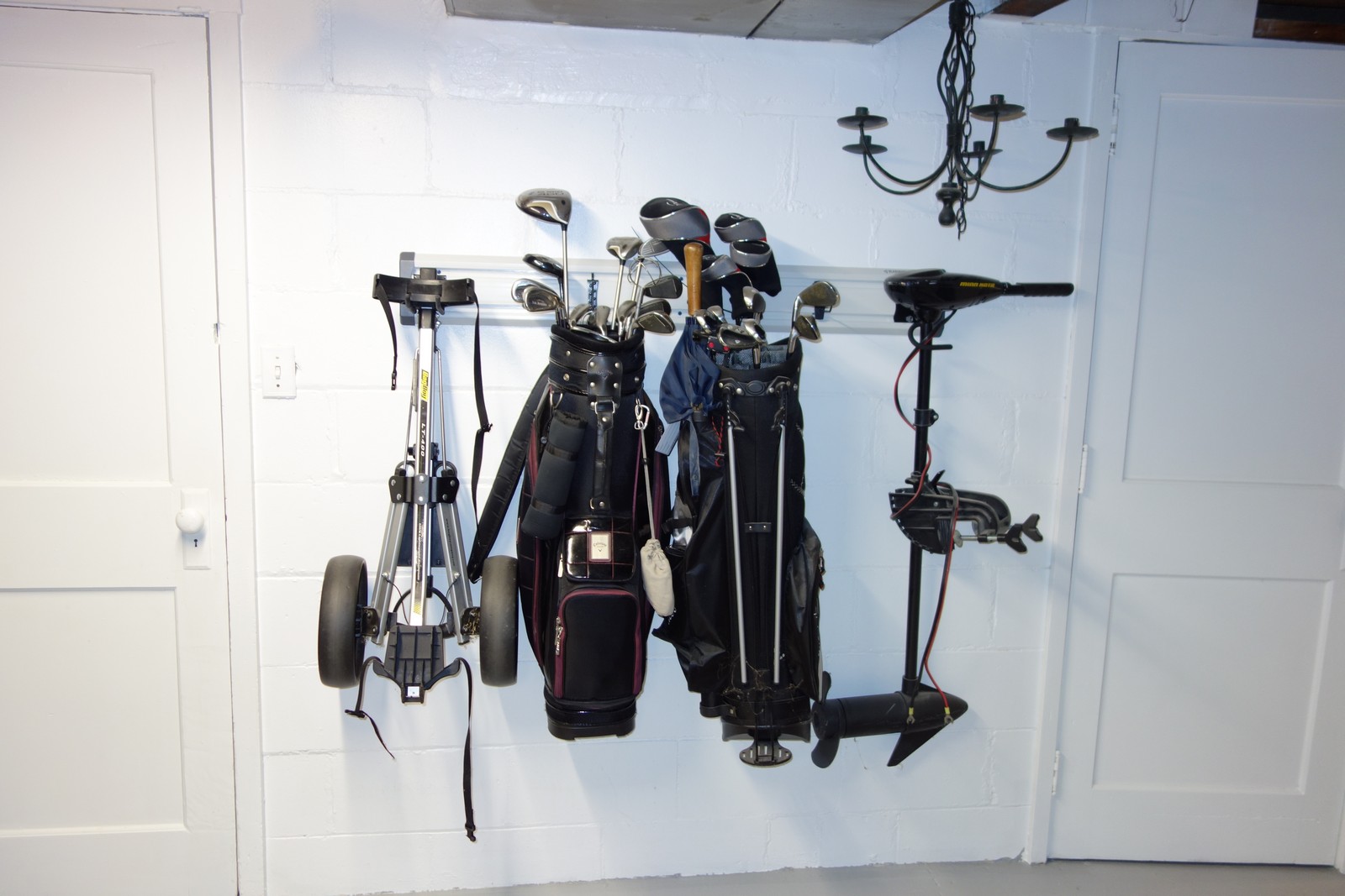 Get those golf bags off the ground and away from basement critters. Geartrak holds a lot of weight easily when properly mounted. The two golf bags and electric boat motor above all weigh "a lot".