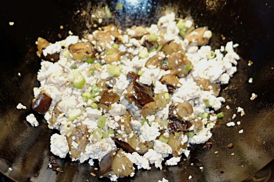 Add the green onions and chicken.