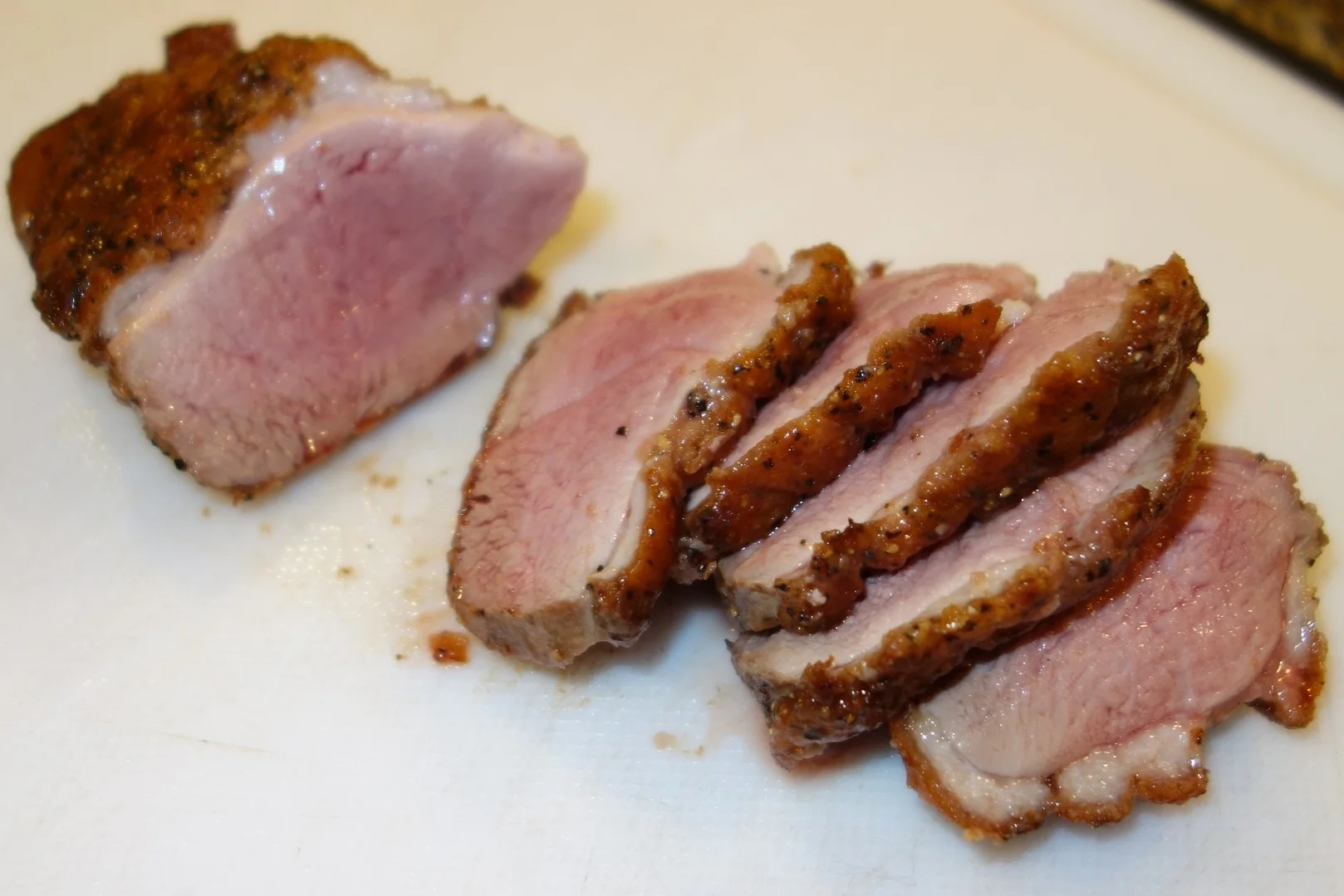 Here are those I cooked using the technque above, finishing them in the oven. While the bottom is not perfect and there is some gray visible, overall they are more uniformly pink than those cooked entirely on the skillet. Your call - these are better but it's more work and most folks won't taste the difference.