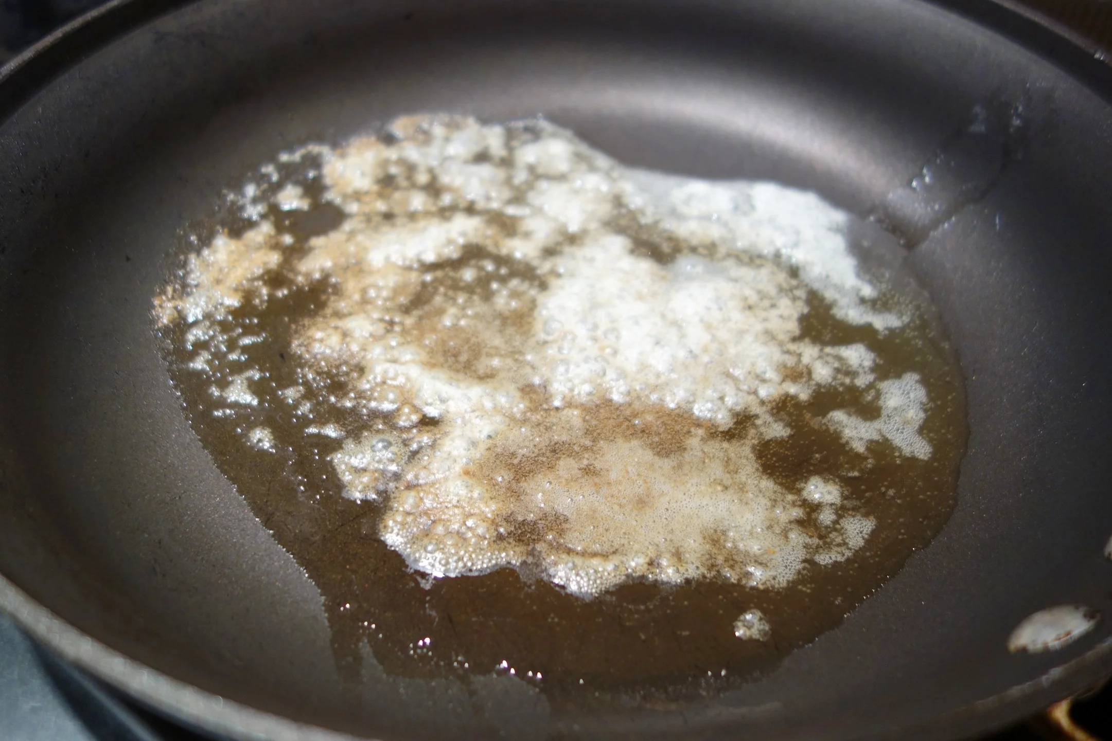Clarify the butter. Put 2 tbsp real butter in a non-stick sauce pan over medium heat. It will foam up as shown.