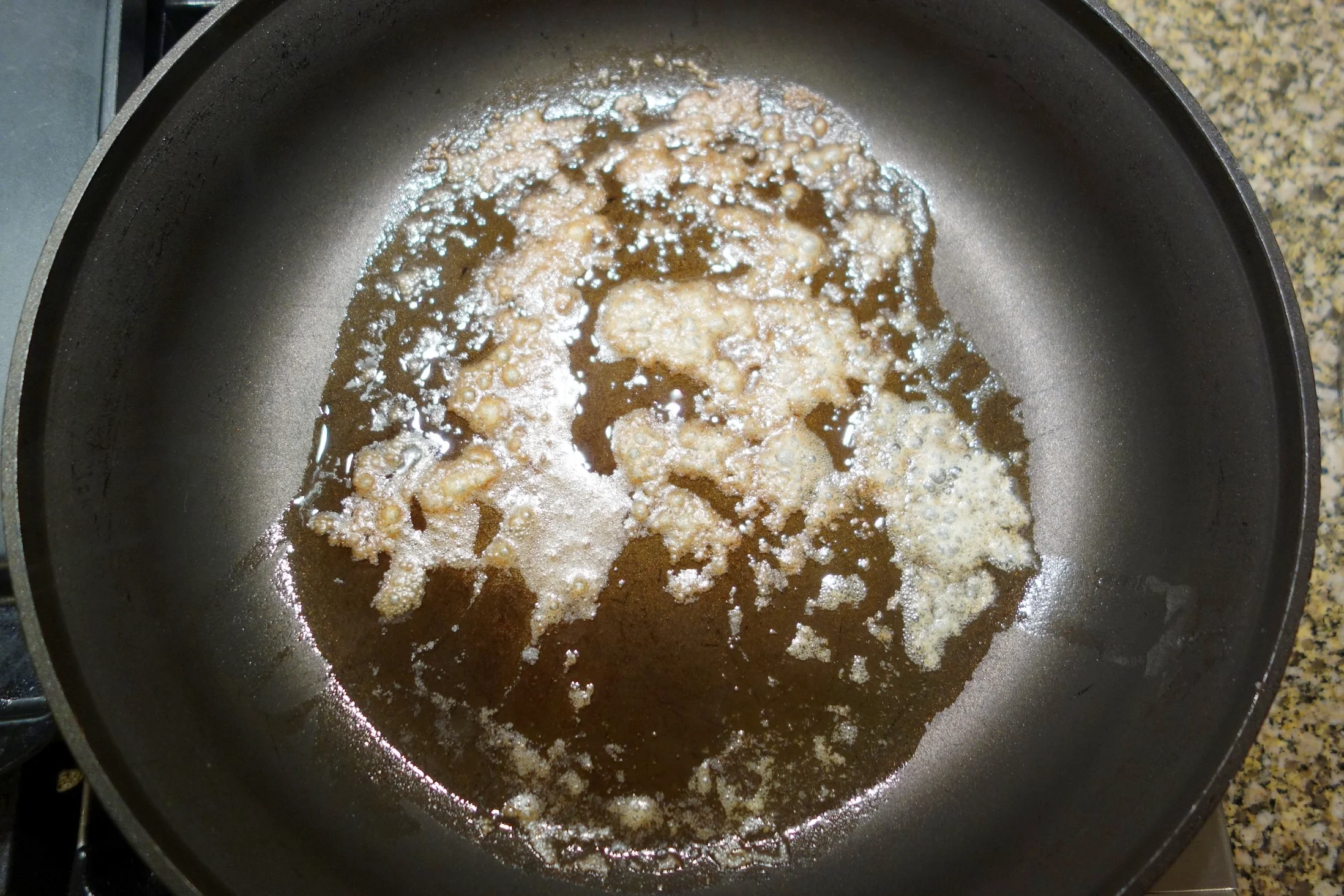 When the foam starts breaking up a bit as shown, it is ready to be strained. 