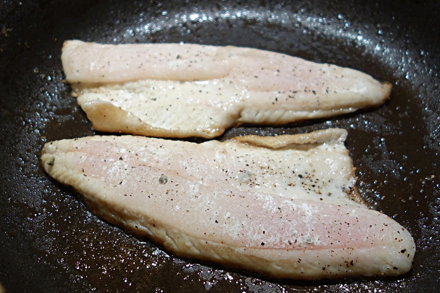 Press down on the fillets gently with a spatula for a minute or so to ensure the skin makes good contact with the pan surface. Continue cooking for about 5 minutes total, monitoring temperature in the thickest part. Flip the fish when the internal temperature is ballpark 110F. 