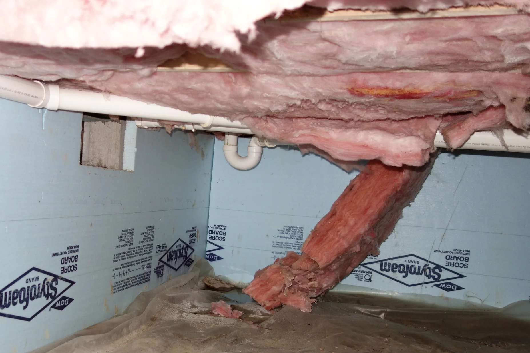 If your under-floor insulation is drooping or falling down, that’s a sign that there has been excessive humidity/moisture in the past. It stays in the insulation, making it heavier and more prone to falling out of place. It also holds that musty/moldy odor. It has to be removed as part of the encapsulation process.
