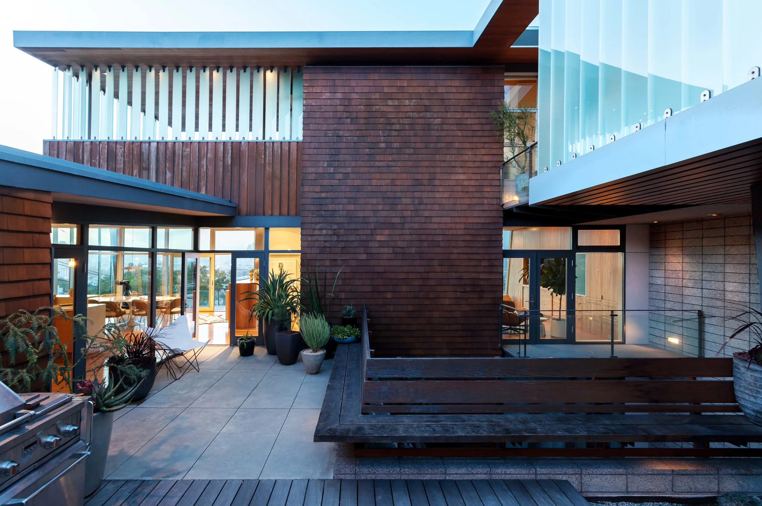 Front courtyard with addition floating above light well that provides light to lowest floor.