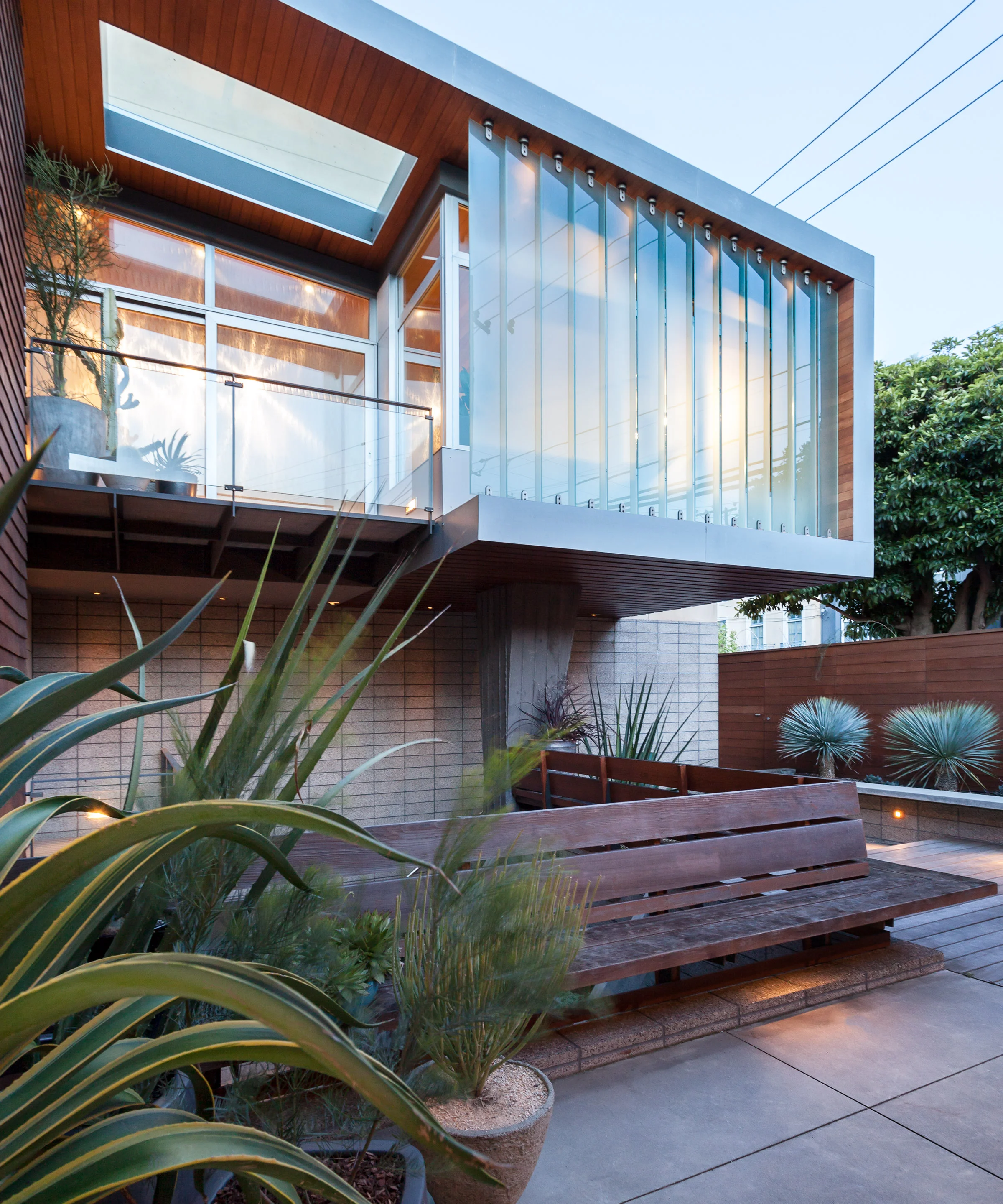 To solve the issue of bringing light down to the lowest floor as well as not reduce the size of the courtyard, the 3rd floor addition hovers above the light well.