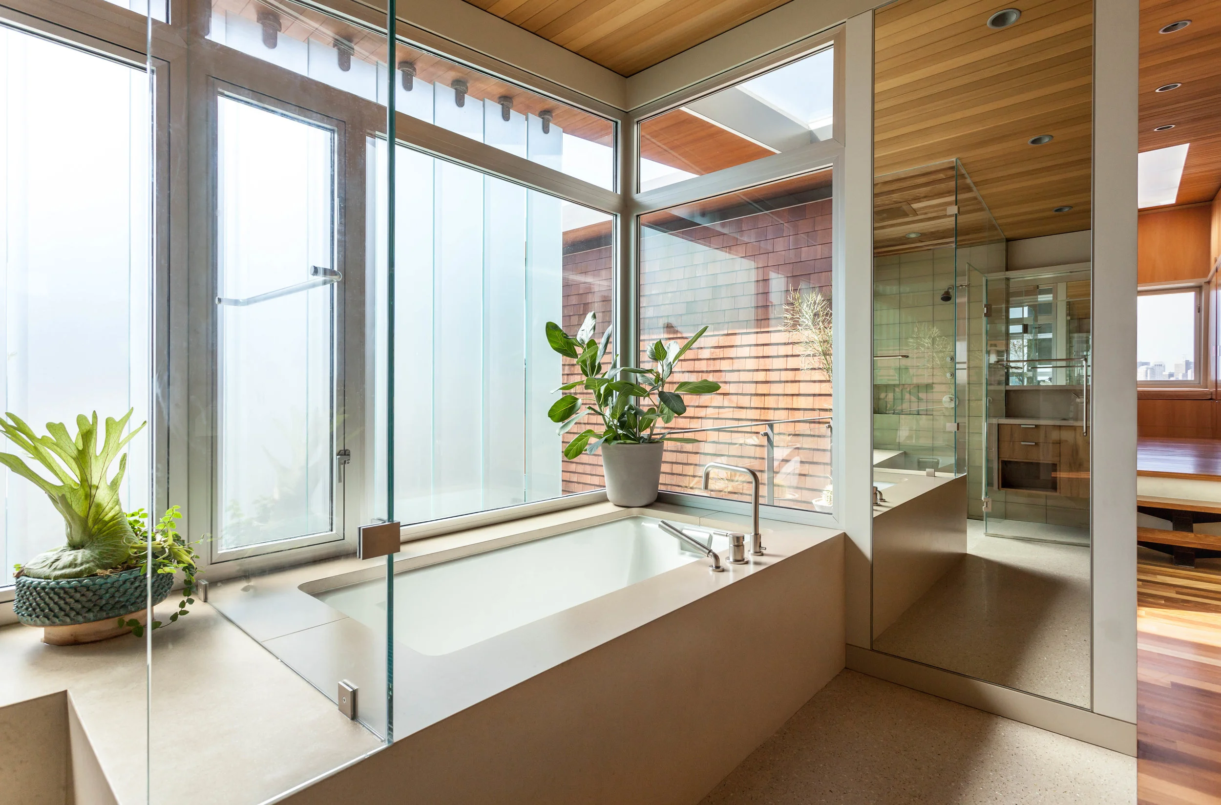 The master bath with operable frosted glass louvers for full privacy and light.