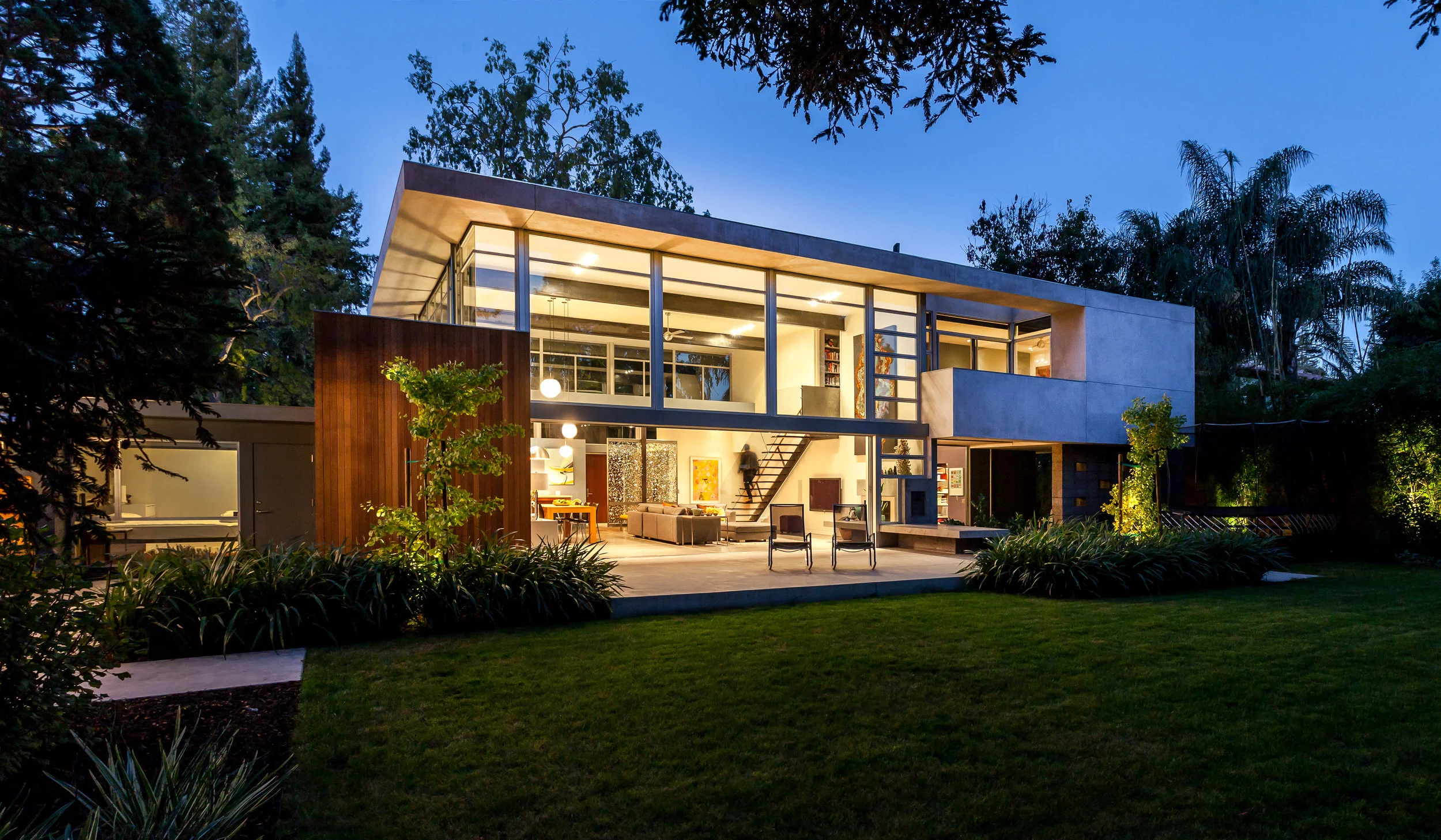 The wall to wall, and floor to ceiling glass help the house to glow at night. The radiant heated floors make even the coolest night toasty warm!