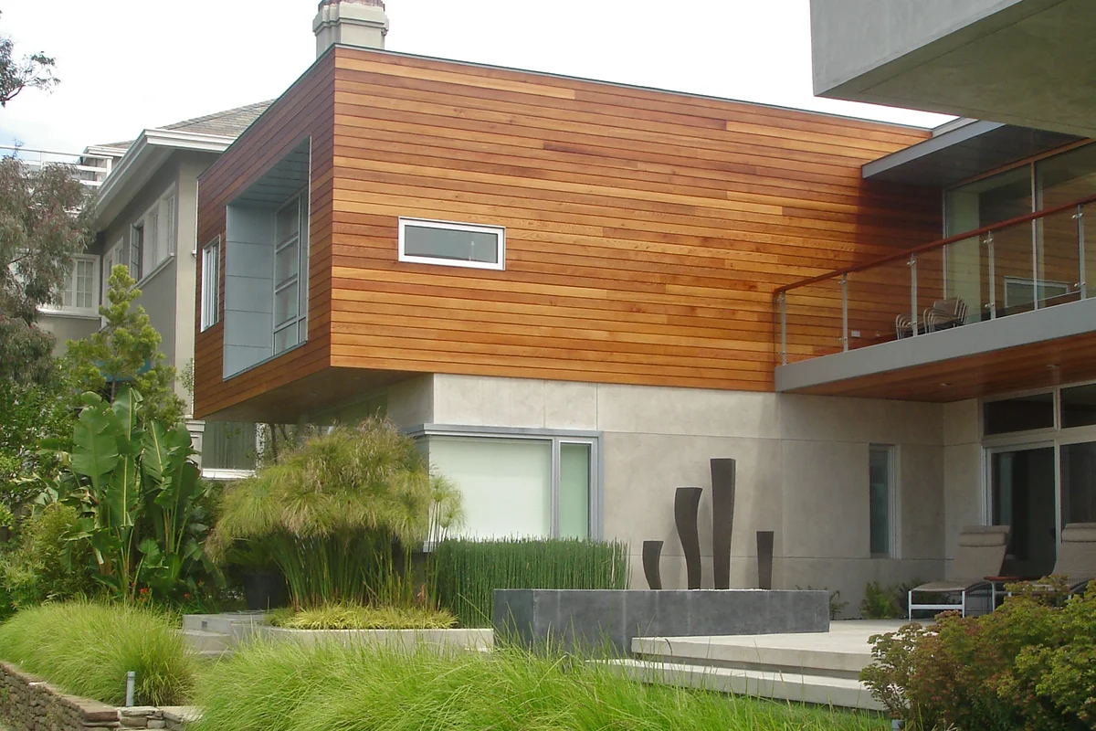 The cedar clad private spaces buffer the rear patio from the neighbors.
