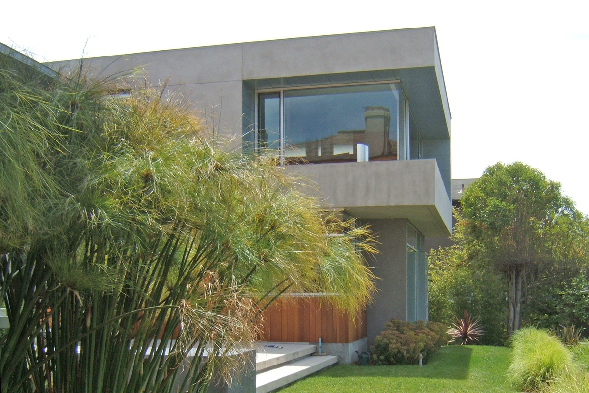 The stucco clad public spaces buffer the rear patio from the other neighbors.