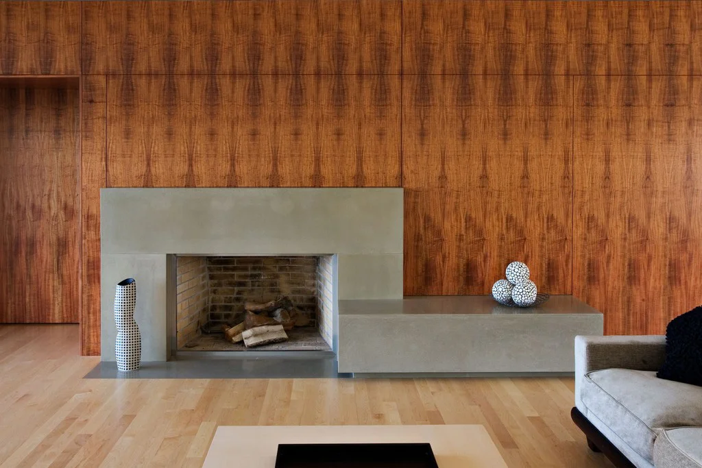 The existing living room fireplace got a koa and concrete facelift.