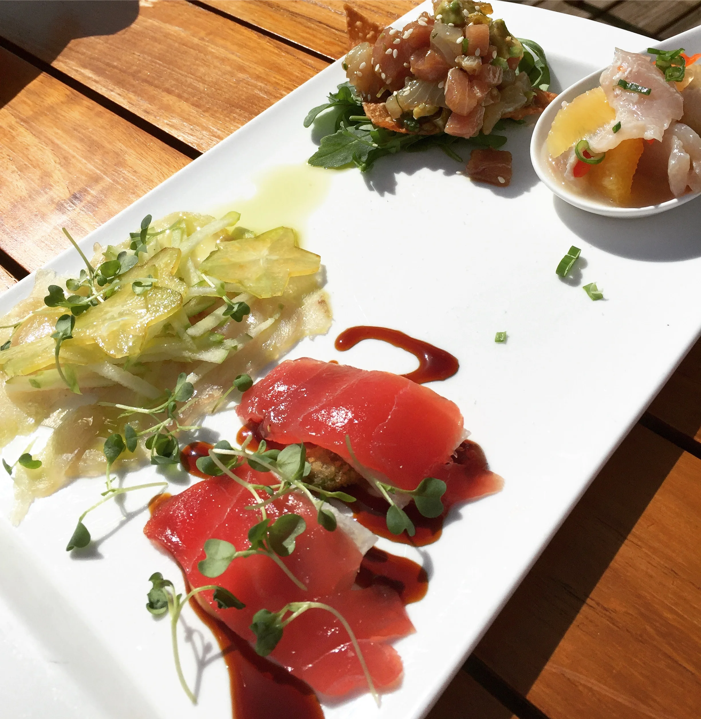 Catch Tasting Plate (clockwise from bottom left): tuna sashimi, local crudo, tuna & wahoo tartare & fresh catch ceviche