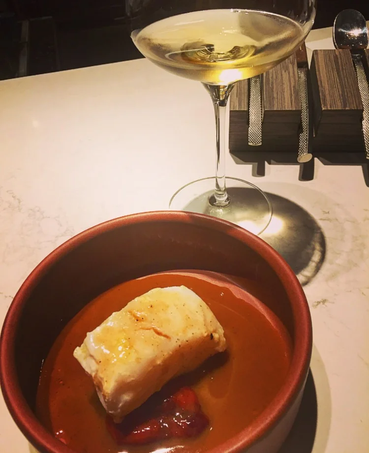 Confit of cod with chicken jus & braised bell peppers