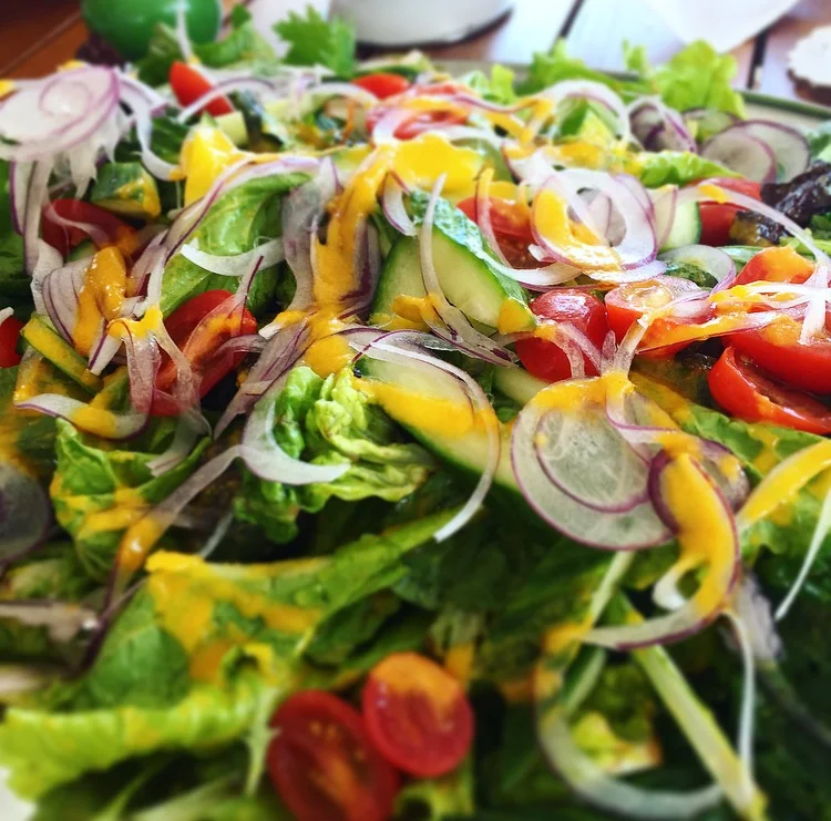 House salad topped with a carrot ginger orange vinaigrette