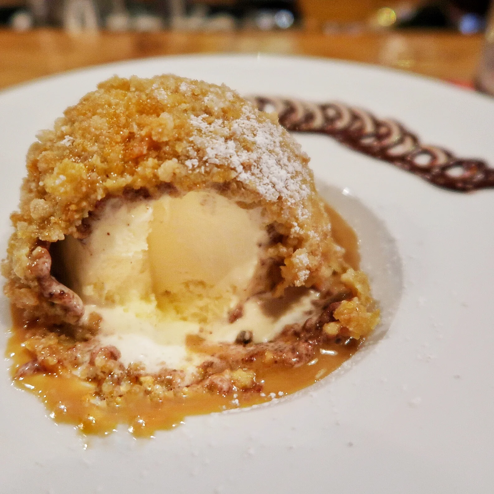 Fried Ice Cream - vanilla ice cream in a crispy corn and cocoa powder shell sits on top of an addictive warm cajeta (Mexican caramel) sauce. One of my favourite desserts on island!