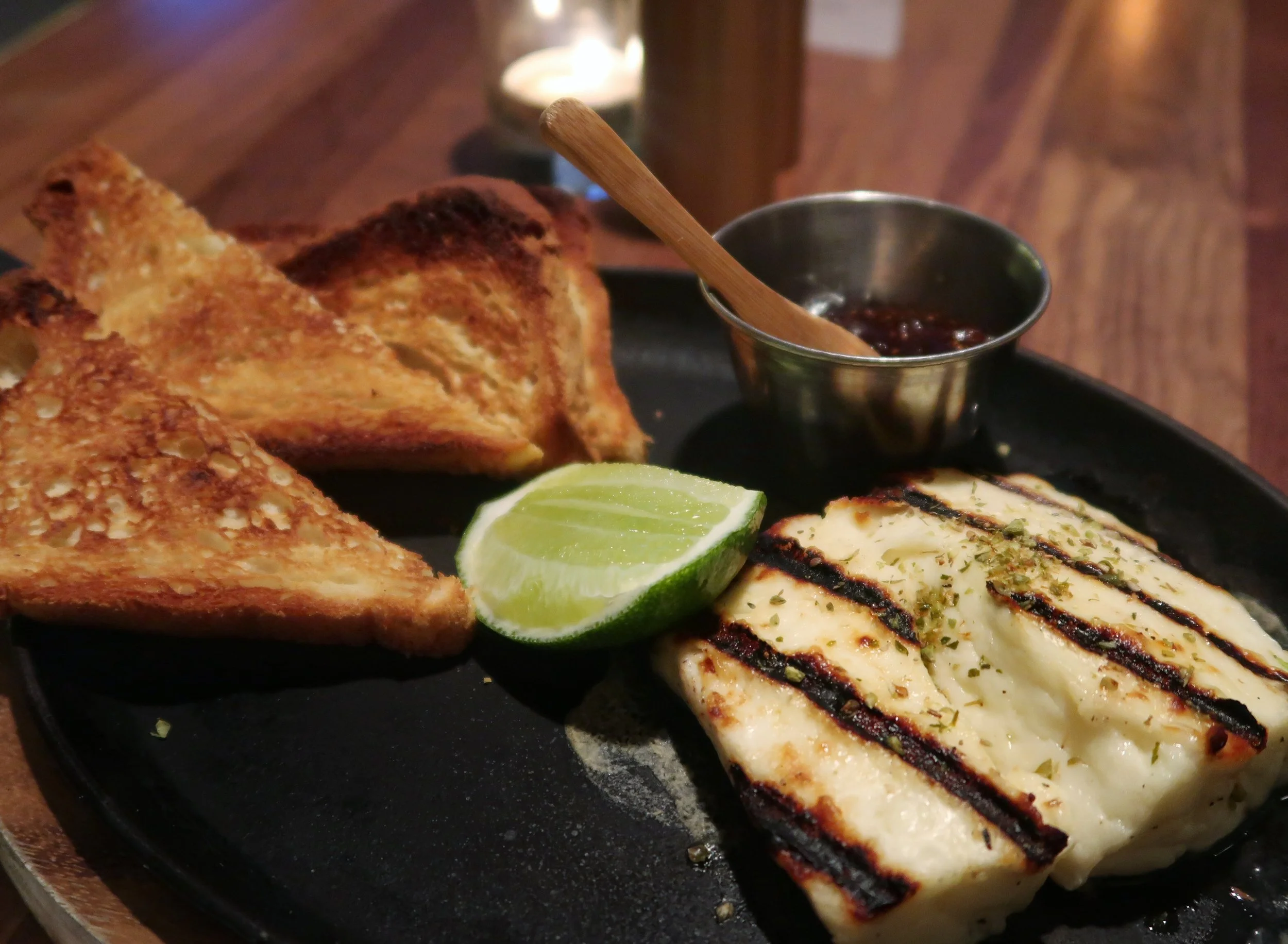 The rich and smoky Halloumi Cheese Flambé served with grilled sourdough (or GF toast), lime and jam. They'll douse it in vodka before lighting it up for you tableside.