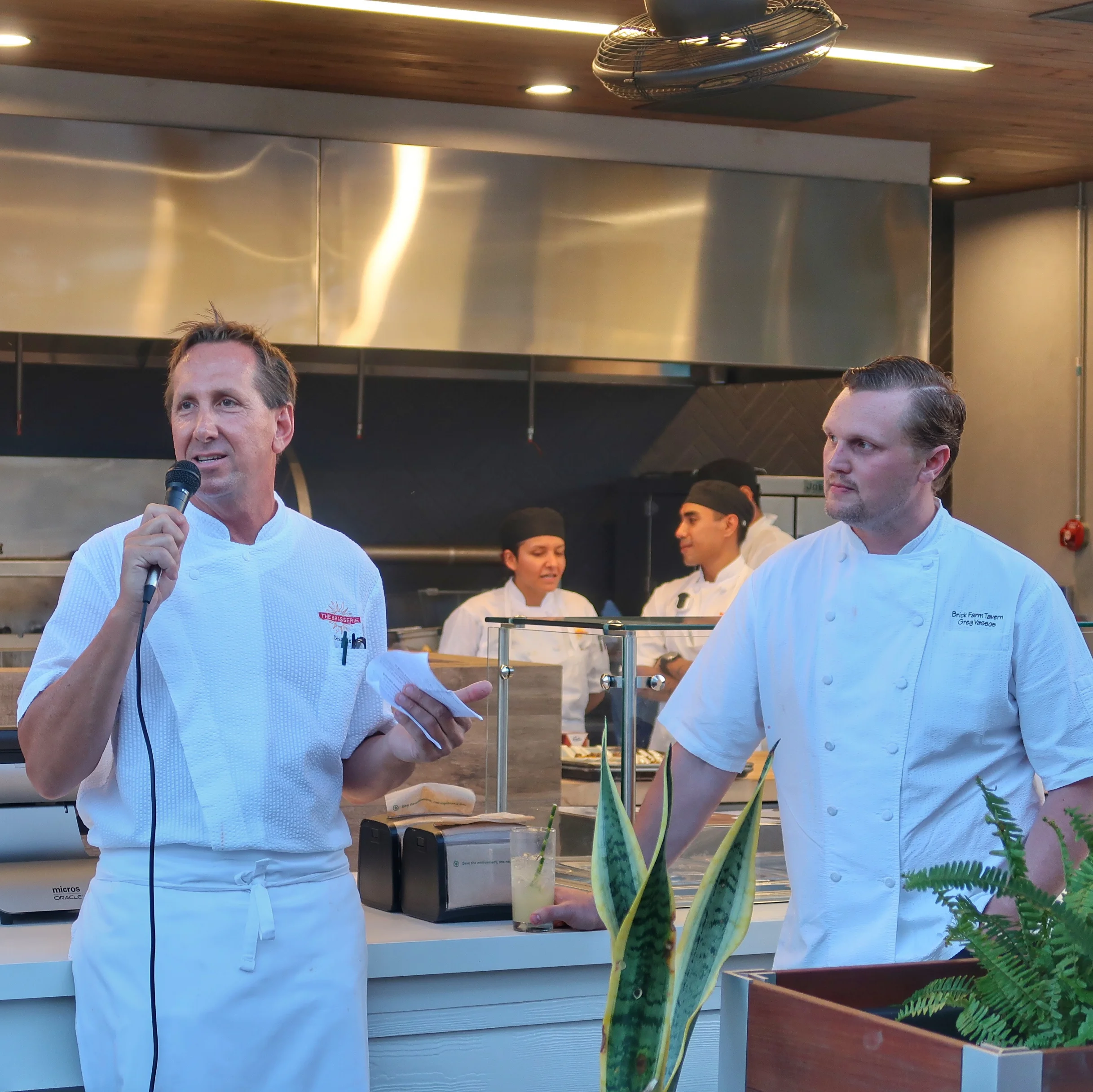 The Brasserie's Consultant Chef Dean Max welcomes guests as Chef Greg Vassos looks on