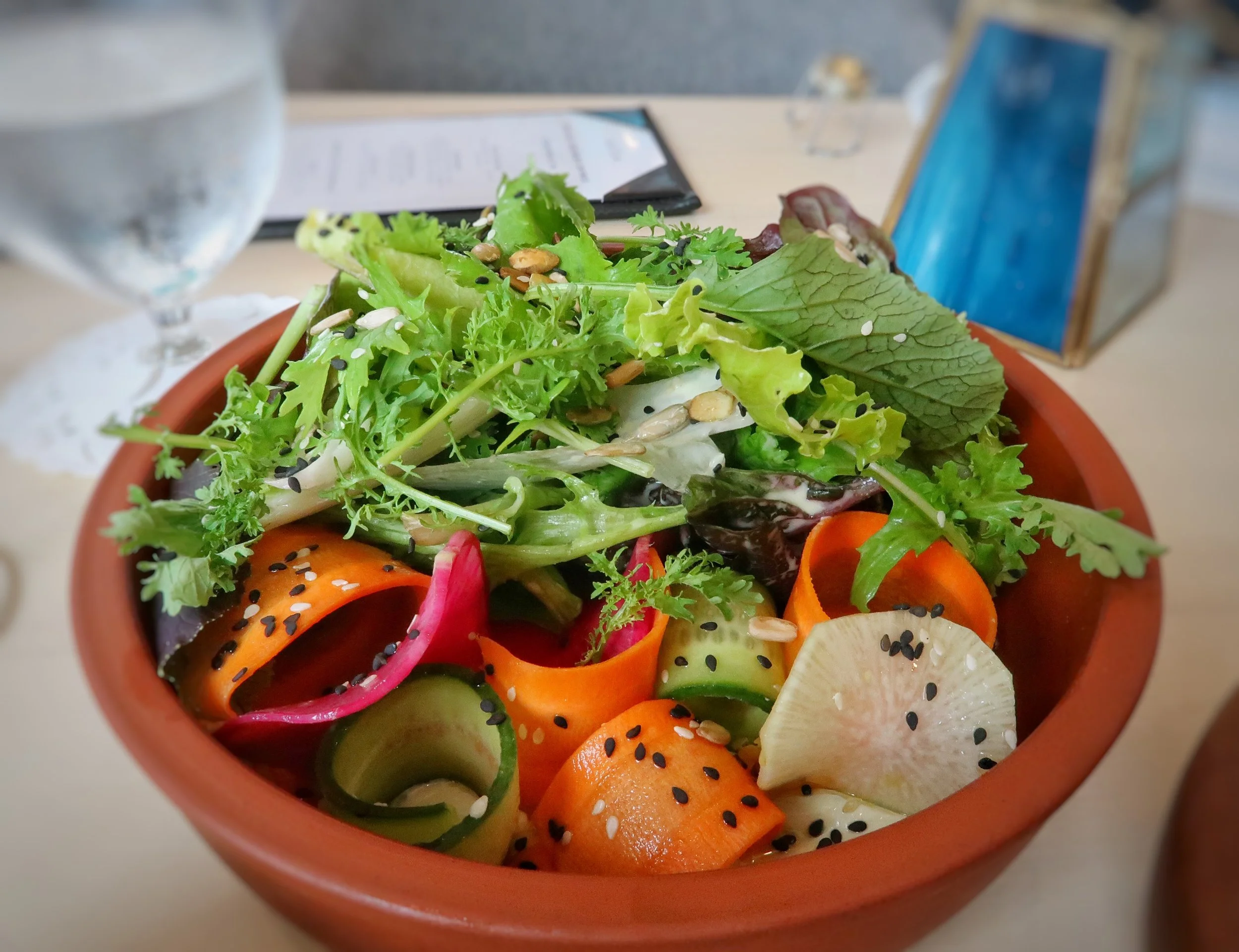 The Misticanza Salad with local crisp greens, crunchy vegetables, seeds, sesame and a delicious cucumber tahini dressing.
