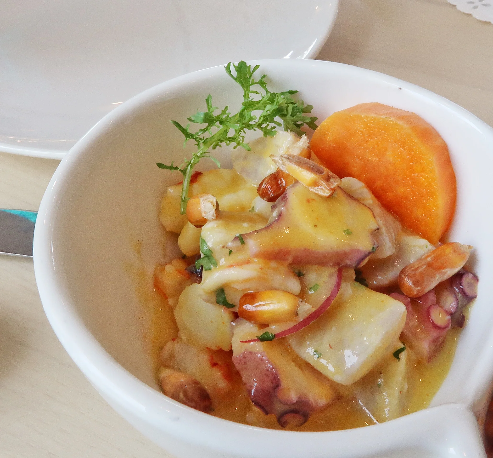Mixto Peruano ceviche has a combination with octopus, fresh catch (wahoo), shrimp, aji amarillo, cilantro, sweet potato and cancha.