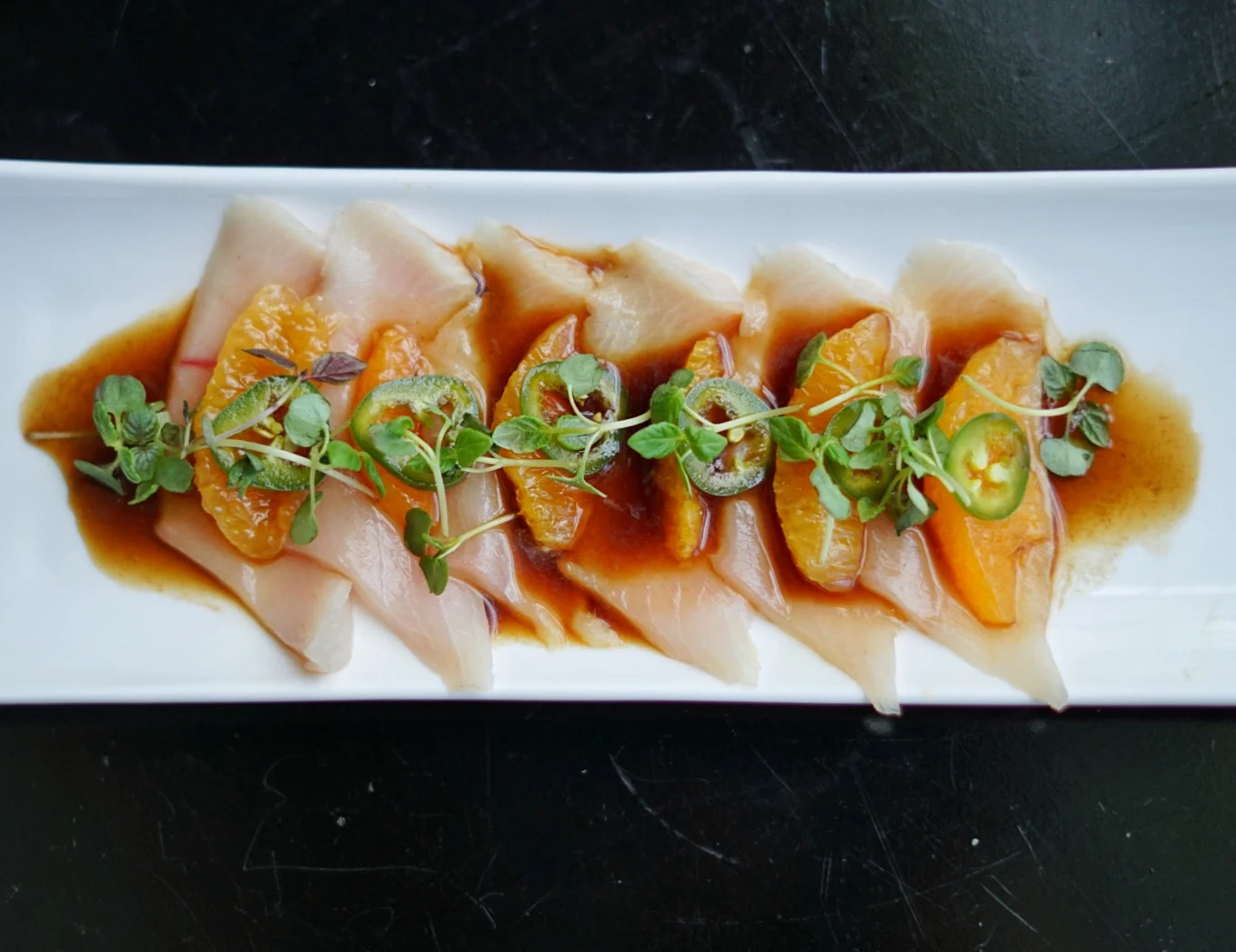 The Yellowtail Jalapeño: Fresh yellowtail topped with jalapeños, Valencia orange and a lemongrass ponzu. Note that the fresh jalapeños make this one particularly spicy so be wary.