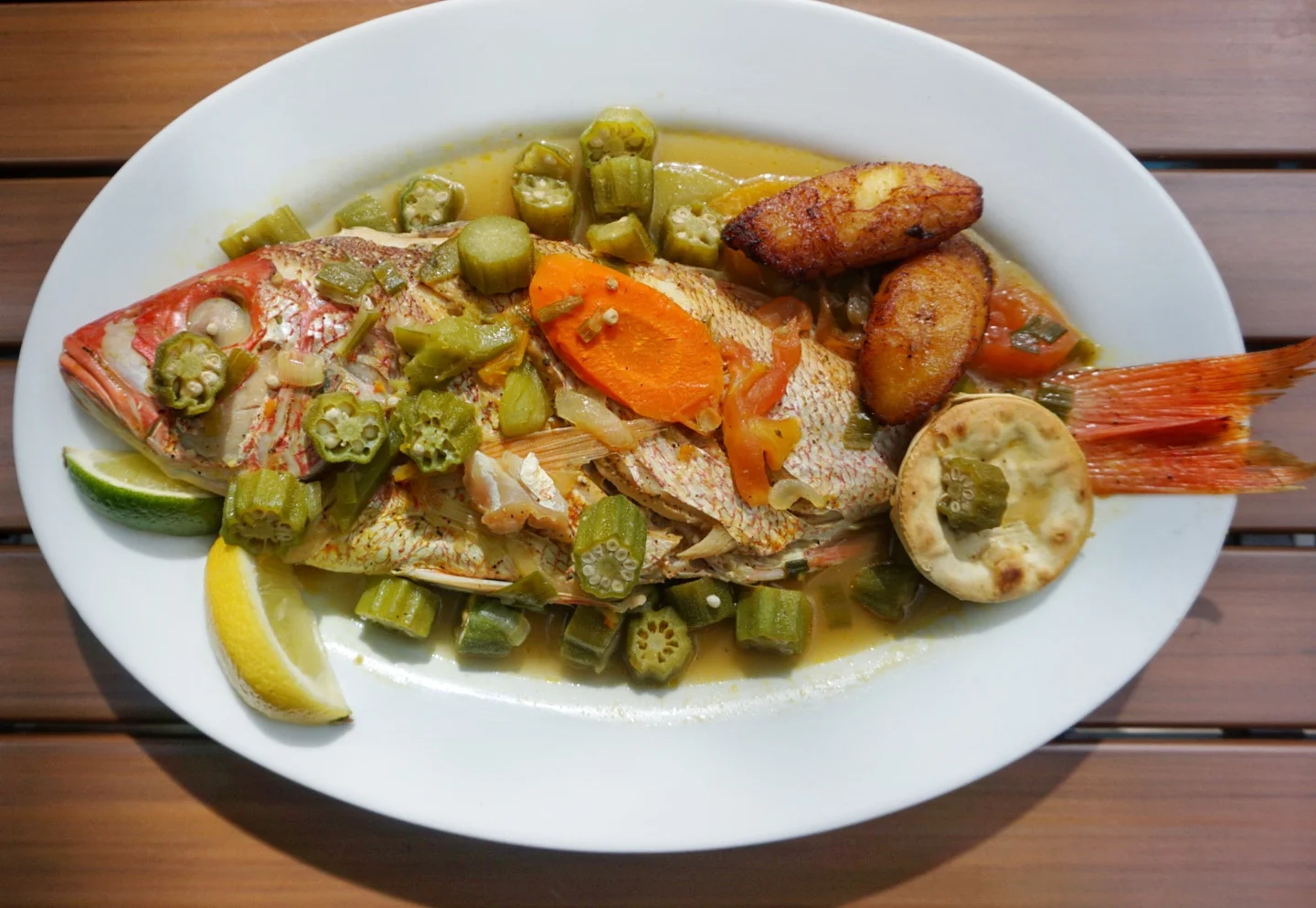 The Whole Snapper can be cooked in a few ways, but we really enjoy the ‘Caribbean Steamed’ version. A whole snapper is steamed alongside okra, carrots, tomatoes, onions and scotch bonnet peppers.