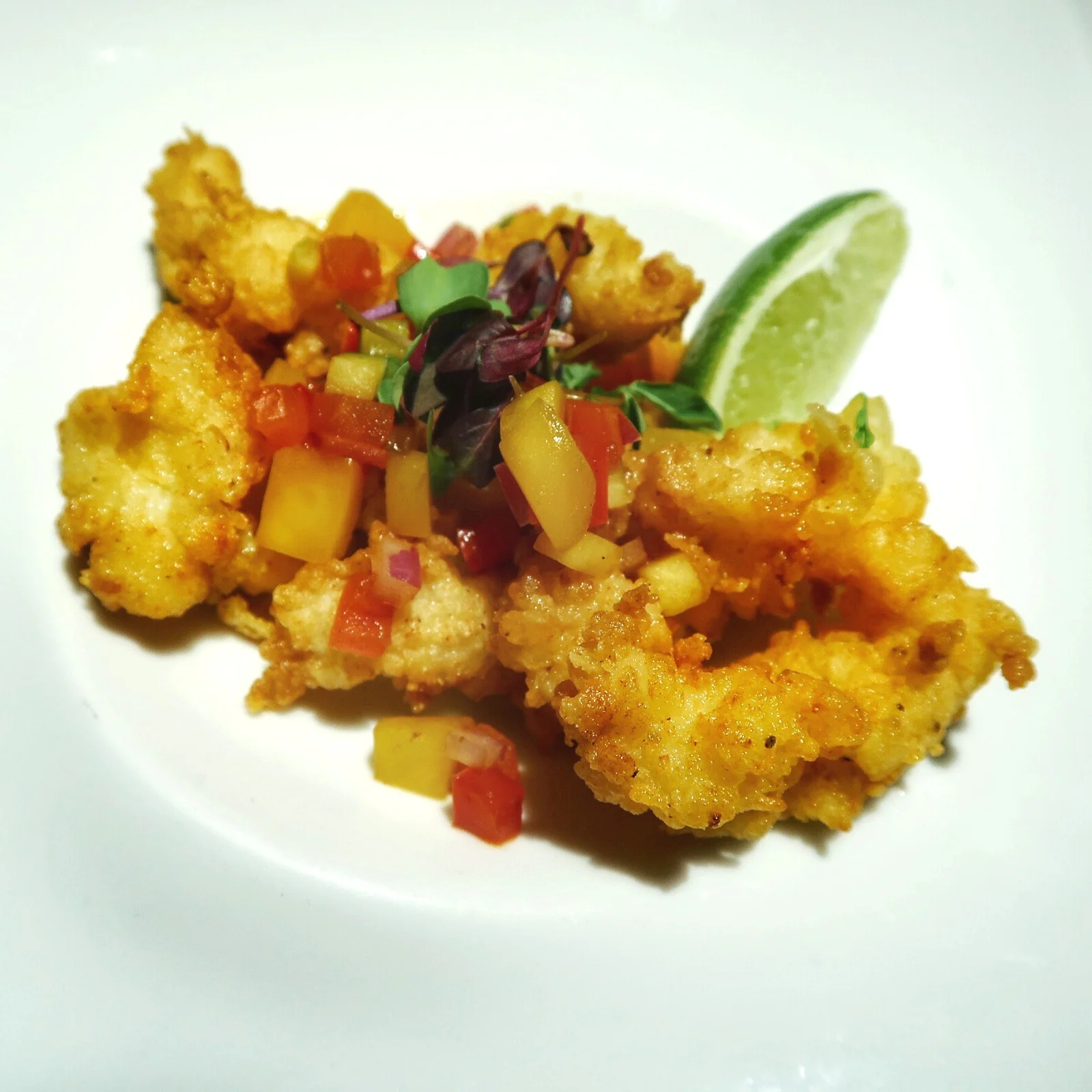 Seven's Cracked Conch dish is the most tender version I've ever had, served with a mango relish, cucumber and jerk aioli