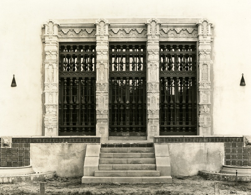 Windows of the Gates Annex library, with columns featuring Mayan Revival reliefs of animals and people.