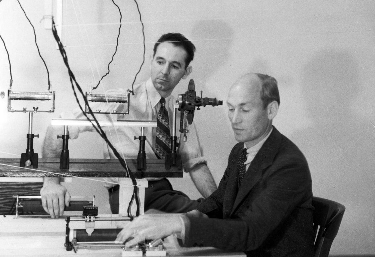 Arnold Beckman and colleague James McCullough at an optical bench, 1934.