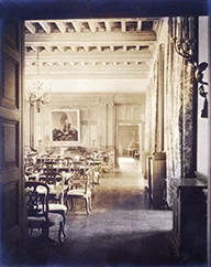 On the back wall, a portrait of George Ellery Hale, Millikan, and Arthur A. Noyes watches over the main dining room of the Athenaeum.