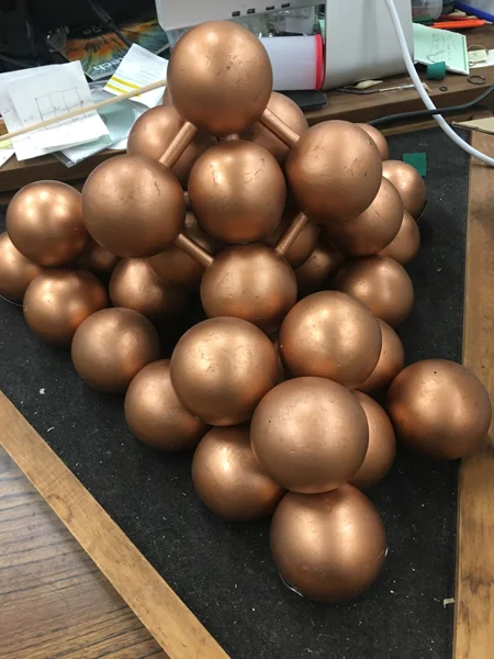 A model of copper metal, with each ball representing an atom. The unit cell (basic building block of the crystal) is a face-centered cube (a cube with eight atoms at the corners and six atoms in the faces) as indicated by the balls connected by rods…