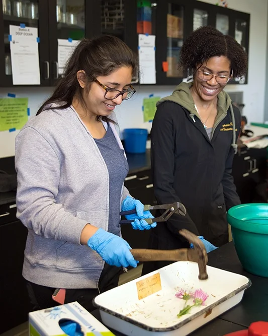 Graduate student Stephanie Threatt (right) shows Blair High School students an experiment involving liquid nitrogen during a recent STEMonstration.