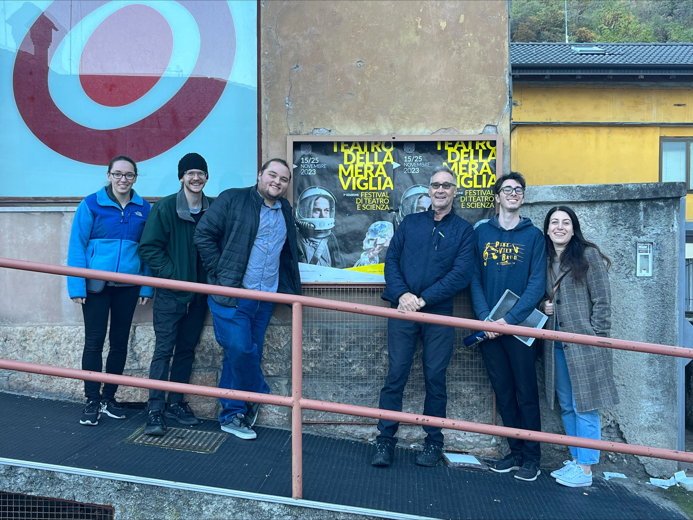   Ware, Engle, Mattinson, Brophy, Gutierrez, and Bircher pose in front of a  Teatro della Meraviglia  poster  