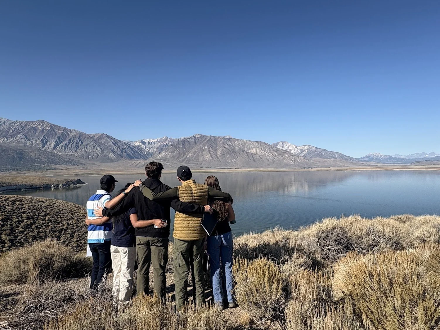  A few of the integrated core students looking across Crowley Lake, with the Sierra Nevada mountains&nbsp;in the background. Credit: Vedant Ganesh 