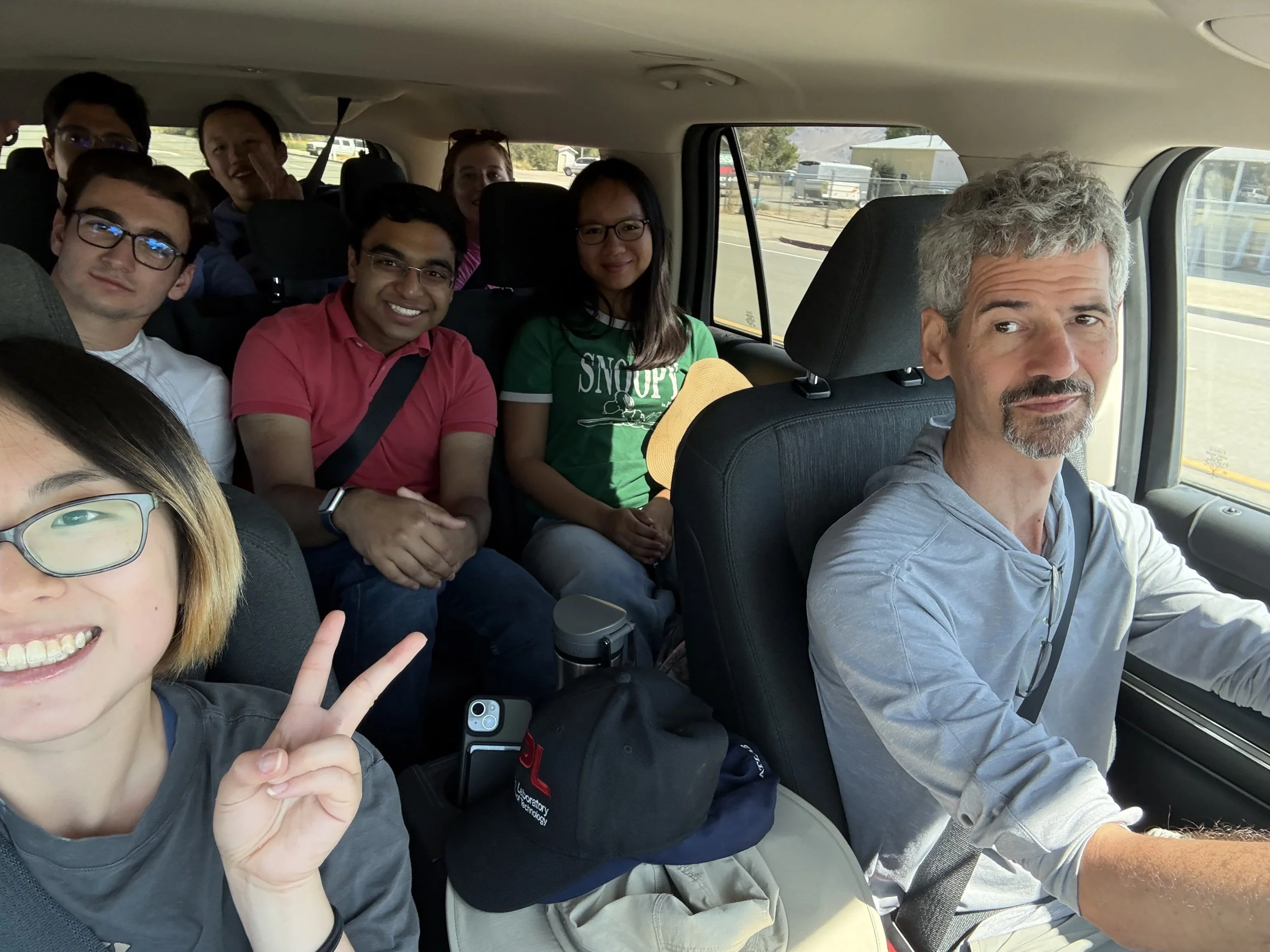  Professor Paul Asimow driving, teaching assistant Yuri Tamama riding shotgun, and six integrated core students on the road to the Coso geothermal plant. Credit: Vedant Ganesh 