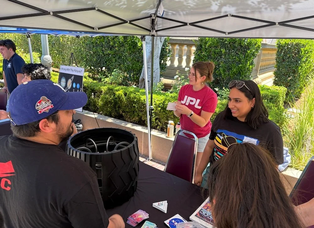  Visitors saw a sample Mars rover wheel up close at the booth organized by JPL, which Caltech founded and manages for NASA. JPL-ers shared educational materials about exoplanets and a giant travel-style poster for Kepler-16b, a world graced by two su