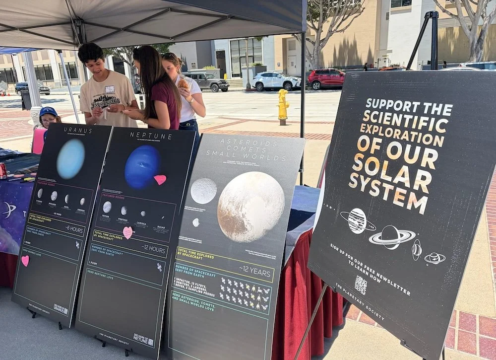  The Planetary Society’s members presented posters extending across four tables that took visitors on a virtual tour of the solar system. Image: Cameron Hummels 