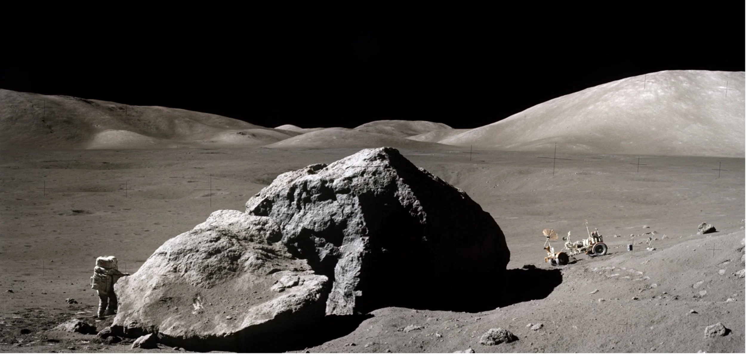   Scientist-astronaut Harrison Schmitt is photographed standing next to a large split lunar boulder during the third Apollo 17 Extravehicular Activity (EVA-3) at the Taurus-Littrow landing site. Credit: NASA  