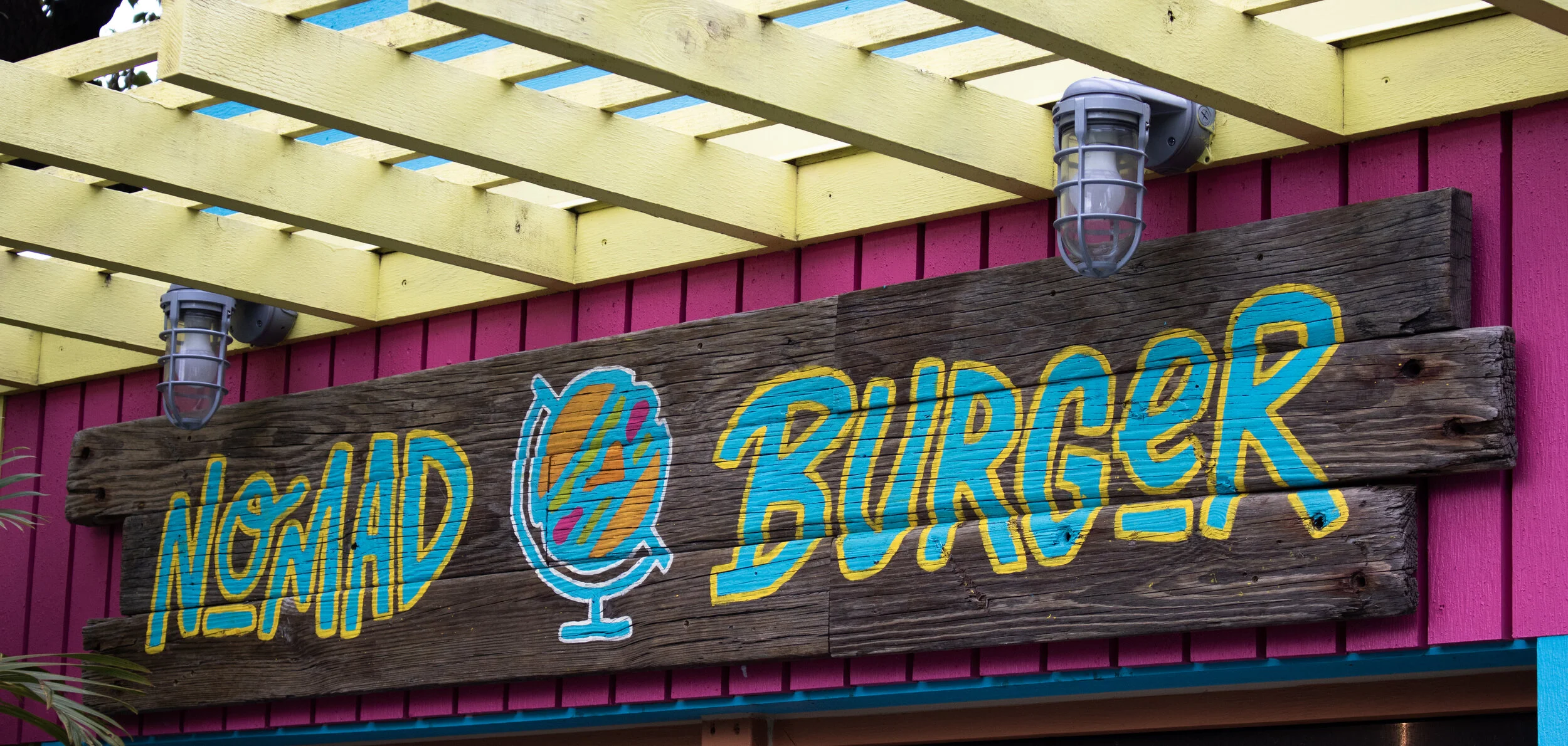 The Nomad Burger sign that hangs on the Burger Shack on the bar’s patio. (Picture by Malachi Lyonsdove)