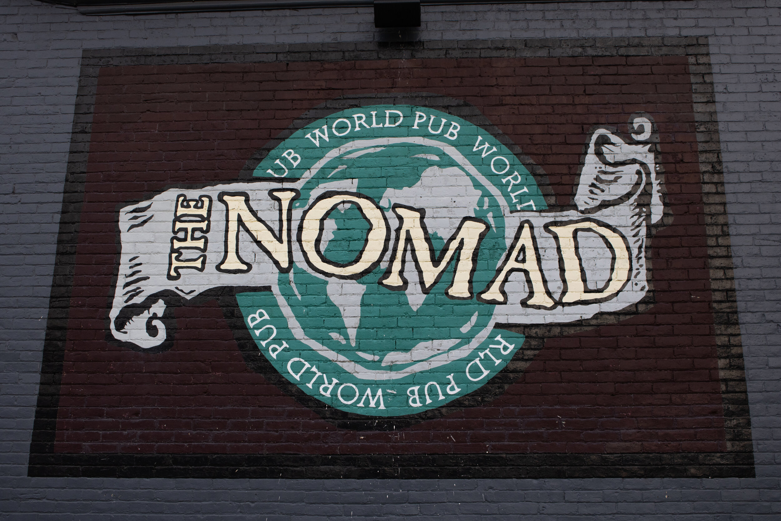 The Nomad World Pub mural painted on the side of the bar.