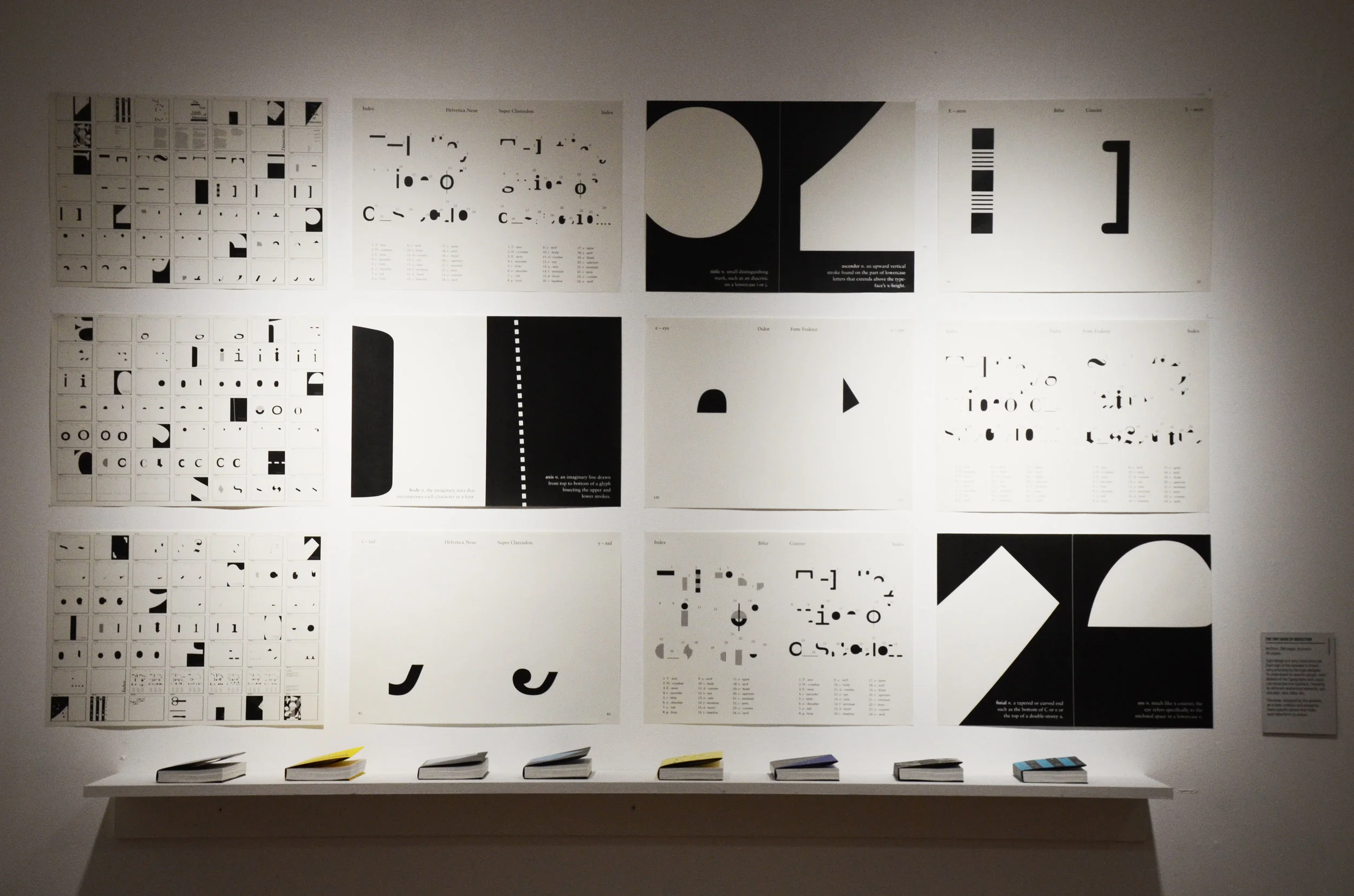 Display of book pages designed by everyone in the typography class, as well as the book covers on display below.