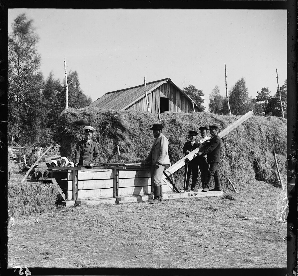 workers on farm bailing hay.jpg