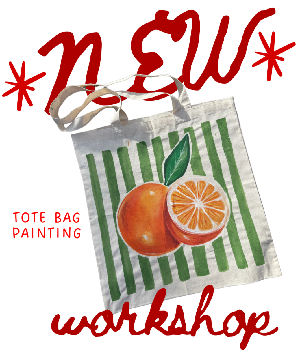A tote bag with a painted design of an orange and orange slices on it, with green and white stripes in the background.