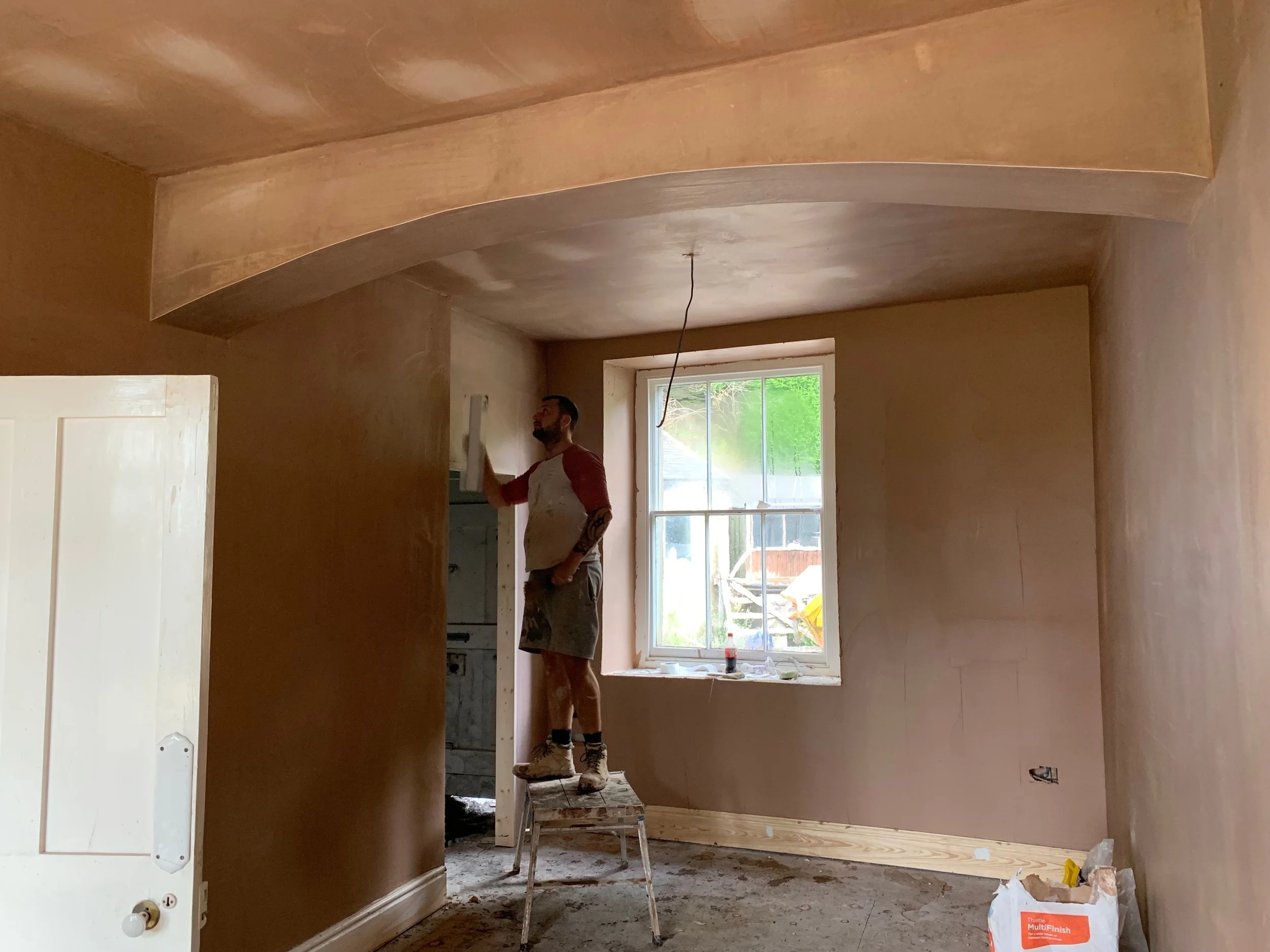 Plasterers finishing off reception room