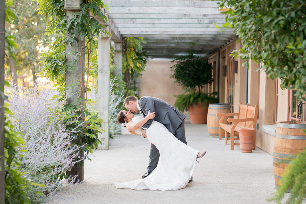photo of groom dipping bride at the towne corner patio